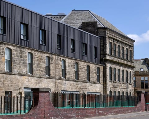 The Linen Quarter in Dunfermline: restored stone mill buildings with a new dark-clad upper storey