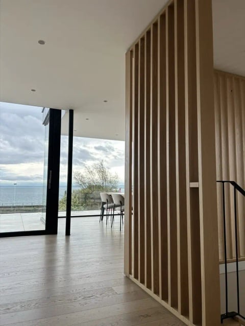 Interior with an oak slat partition and full-height glazing